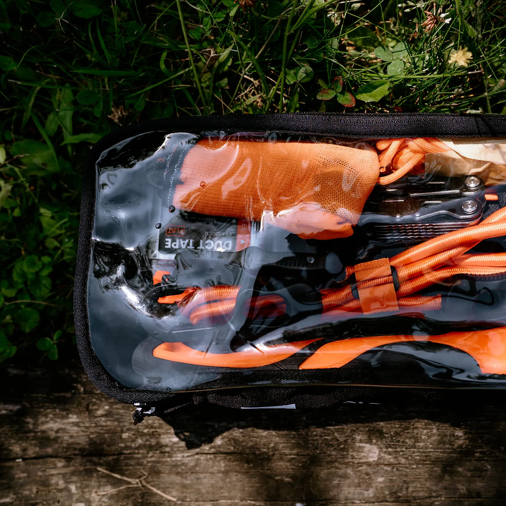 Zamknięty moduł TOOLS HELP BAG, przez przezroczysty panel widać multitool, taśmę i paracord
